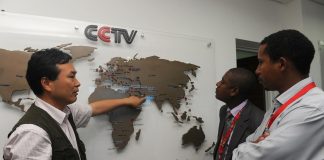 The managing editor of China Central Television Africa, Pang Xinhua, shows a local journalist in Nairobi how the organization has expanded in different parts of Africa on June 12, 2012. (Simon Maina/AFP/GettyImages)