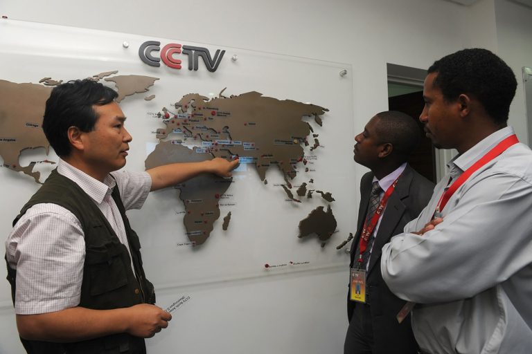 The managing editor of China Central Television Africa, Pang Xinhua, shows a local journalist in Nairobi how the organization has expanded in different parts of Africa on June 12, 2012. (Simon Maina/AFP/GettyImages)