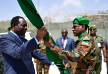 Ambassador Francisco Madeira, the Special Representative of the Chairperson of the African Union Commission (SRCC) for Somalia hands an African Union flag to Lt. Gen. Tigabu Yilma Wondimhunegn, the new AMISOM Force Commander. This was during an AMISOM Force command handover/takeover ceremony in Mogadishu, Somalia, on 31 January 2018. AMISOM Photo / Ilyas Ahmed