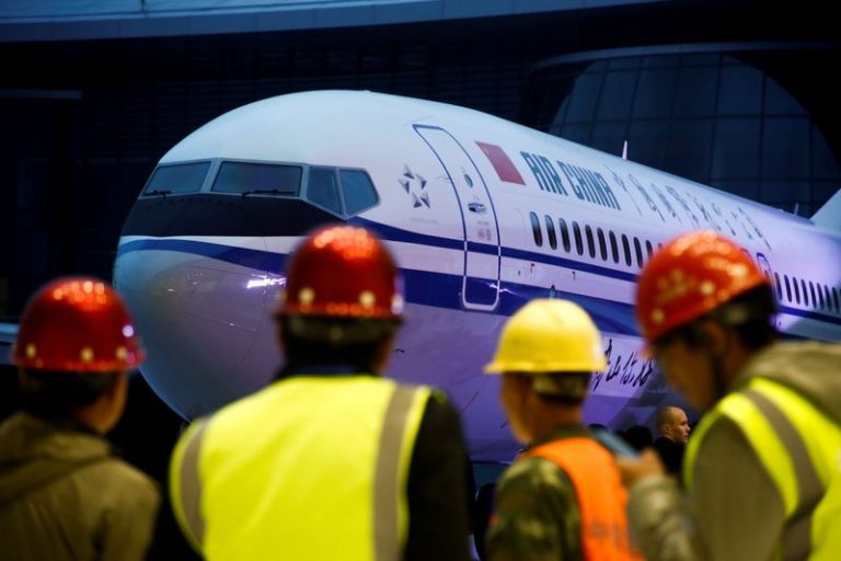 Workers attend a ceremony marking the 1st delivery of a Boeing 737 Max 8 airplane to Air China at the Boeing Zhoushan completion center in Zhoushan, Zhejiang province, China, December 15, 2018. REUTERS/Thomas Peter/Files