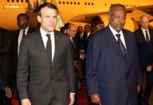 French president Emmanuel Macron (C) is welcomed by Djibouti's president Ismail Omar Guelleh upon his arrival at Djibouti's airport, March 11, 2019, in Djibouti, at the start of his trip to eastern Africa