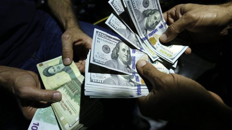 File photo showing a man exchanging Iranian rials for US dollars in Tehran, Iran (photo credit BBC)