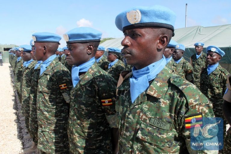 Soldiers stand guard during the formal inauguration ceremony of the United Nations Guard Unit (UNGU), a defensive military enity mandated to protect UN staff and installations in Mogadishua, capital of Somalia, May 18, 2014. The UNGU is made up of 410 troops provided by the Uganda People's Defence Forces. The Guard Unit, led by a Ugandan Commander, falls under the responsibliity of the UN designated official in Somalia. (Xinhua/Faisal Isse)