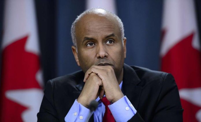 Minister of Immigration, Refugees and Citizenship Ahmed Hussen pauses in Ottawa on Tuesday, May 7, 2019. Immigration Minister Ahmed Hussen says he is concerned by numbers in a new poll that suggest a majority of Canadians believe the government should limit the number of immigrants it accepts since the country might be reaching a limit to its ability to integrate them. THE CANADIAN PRESS/Sean Kilpatrick