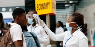 A health worker checks the temperature of a traveller as part of the coronavirus screening procedure at the Kotoka International Airport in Accra, Ghana on January 30, 2020 [Francis Kokoroko/Reuters]