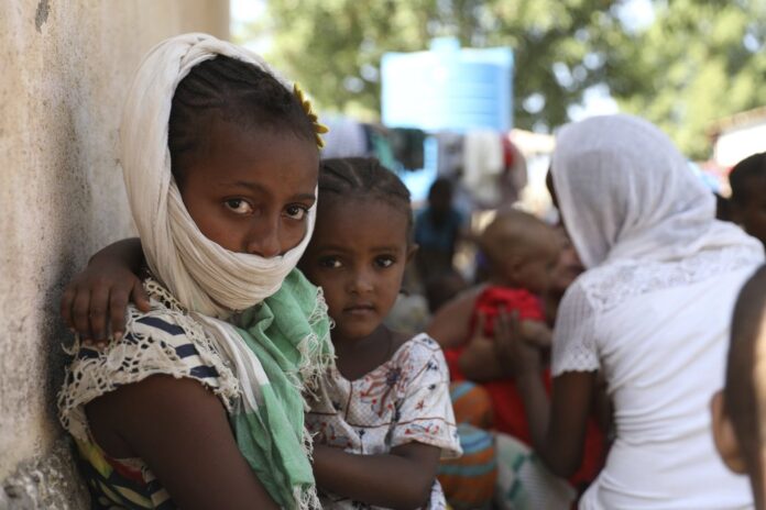 Refugees from the Tigray region of Ethiopia region wait to register at the UNCHR center at Hamdayet, Sudan on Saturday, Nov. 14, 2020. Ethiopia’s defiant Tigray regional government has fired rockets at two airports in the neighboring Amhara region as a deadly conflict threatens to spread into other parts of Africa’s second-most populous country. (AP Photo/Marwan Ali)