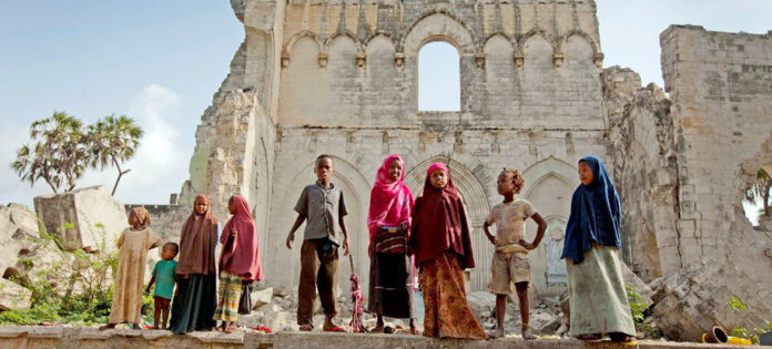 IRIN/Kate Holt Children stand before the remains of Mogadishu cathedral, built by the Italian colonial authorities in Somalia. (file)