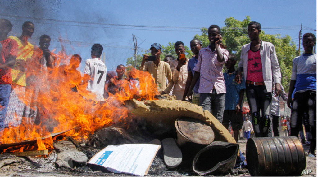 Anti-government protesters burn photographs of President Mohamed Abdullahi Mohamed, also known as Farmajo, in the Fagah area of Mogadishu, Somalia, April 25, 2021.