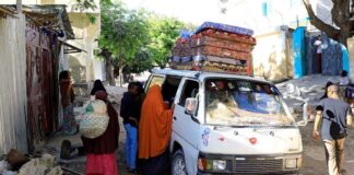 Residents flee following renewed clashes between rival factions in the security forces, who have split in a dispute over an extension to the president's term in Hodan district of Mogadishu, Somalia, on April 27, 2021. (Reuters)