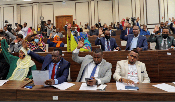 Somalia legislators vote by rising their hands to cancel a divisive two-year presidential term extension, inside the lower house of Parliament in Mogadishu, Somalia May 1, 2021. REUTERS/Feisal Omar