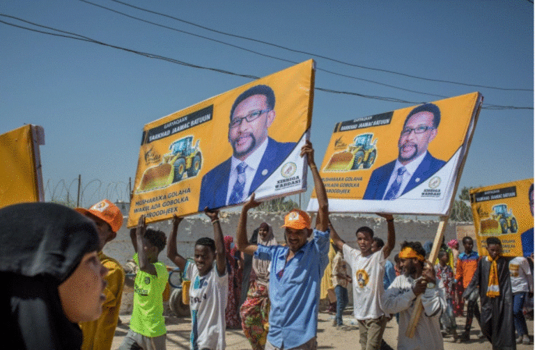 Supporters hold banners of candidates during a rally of the opposition Waddani Party on May 25 [File: AFP]