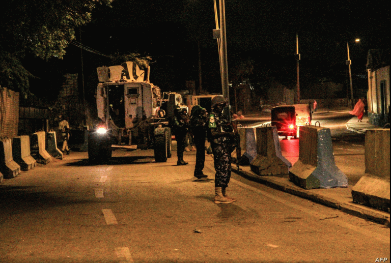 FILE - Police officers of the African Union's peacekeeping mission in Somalia (AMISOM) patrol on a street in Mogadishu, Somalia, Sept. 17, 2019. The country is bracing for attacks by the al-Shabab terror group during upcoming elections.