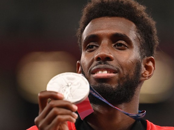 Canada's Mohammed Ahmed celebrates his silver medal on the podium during the medal ceremony for the men's 5000m event during the Tokyo 2020 Olympic Games. PHOTO BY INA FASSBENDER /AFP via Getty Images