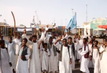 Sudanese protesters gather outside the main entrance to the southern port in Port Sudan [File: Ibrahim Ishaq/AFP