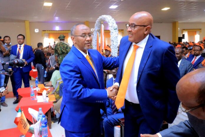 the founder and former chairman of Waddani Party Abdirahman Mohamed Abdilahi Irro shakes hands with newly elected party chairman Hersi Ali Haji Hassan