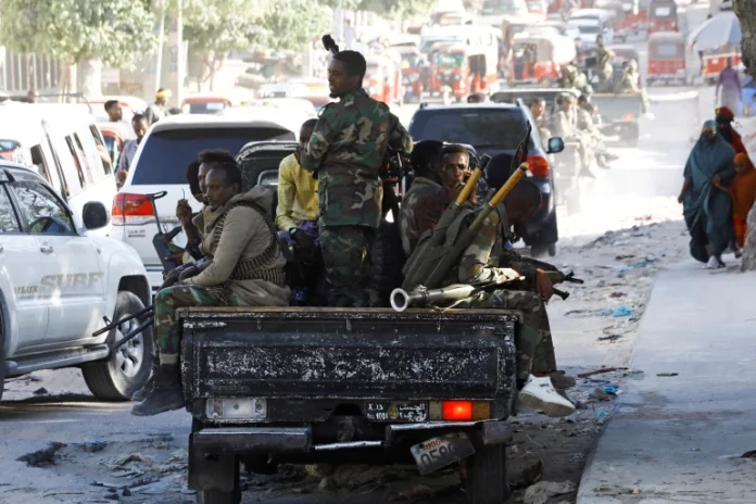 Somali military supporting Prime Minister Mohamed Hussein Roble ride on their pick-up trucks as they gather at Siigale village in Hodan district of Mogadishu, Somalia December 27, 2021. REUTERS/Feisal Omar
