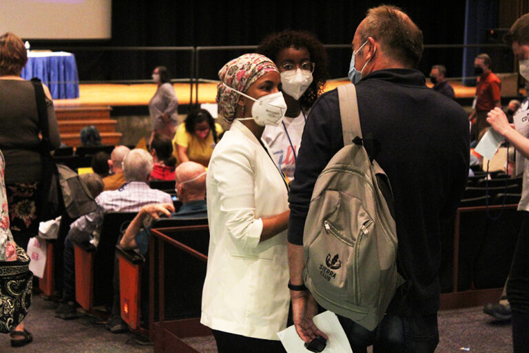Rep. Ilhan Omar, left in mask and her daughter Isra, talk to a delegate during the DFL Fifth Congressional District endorsement convention on Saturday, May 7, 2022 where she won the endorsement in her reelection bid. Photo: Jasmine Webber/Mshale