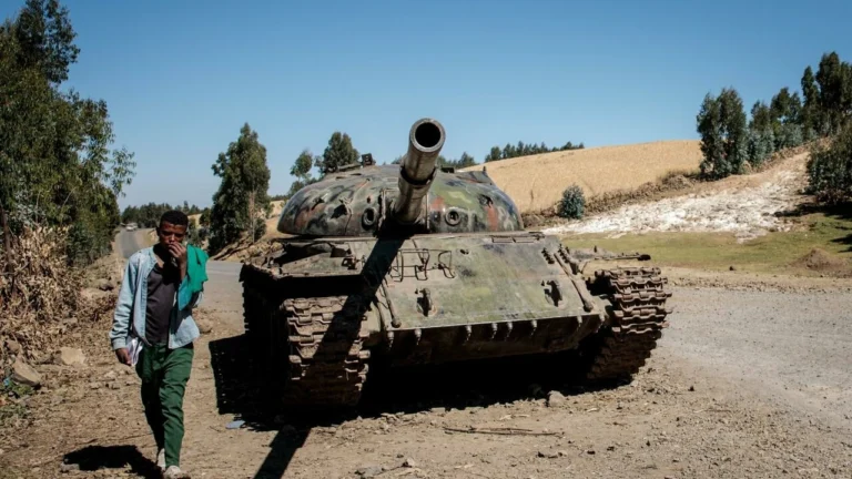 File photo: A man walks past a tank said to have belonged to Tigray People's Liberation Front (TPLF) rebels near Debre Tabor, on December 6, 2021. © Solan Kolli, AFP