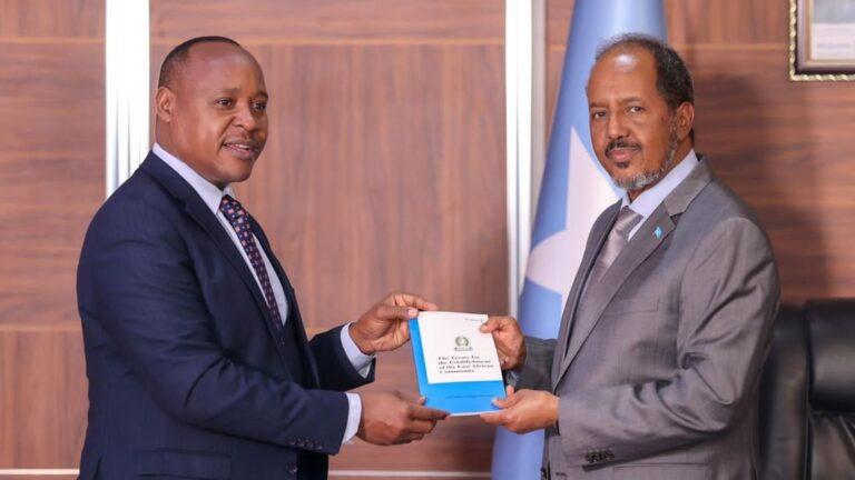 EAC Secretary-General Peter Mathuki (left) presents a copy of the Treaty for the Establishment of the EAC to Somalia President Hassan Mohamud in Mogadishu. PHOTO | COURTESY | EAC