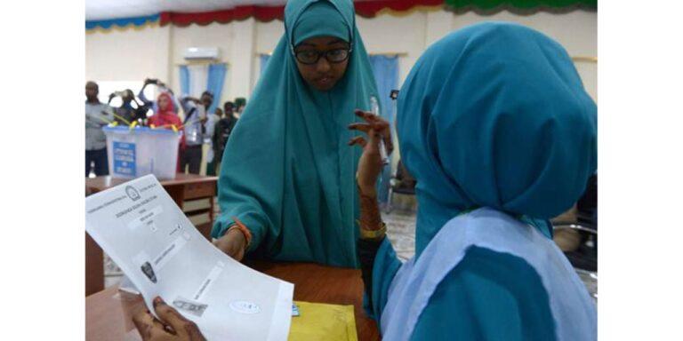 A Somali polling agent (right) explains the voting procedure to a voter before she casts her ballot in Baidoa during a past election.