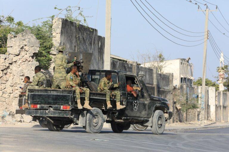 Security forces patrol outside a building that was attacked by suspected al-Shabab militants in Mogadishu, capital of Somalia, on Feb. 21, 2023. (Photo by Hassan Bashi/Xinhua)