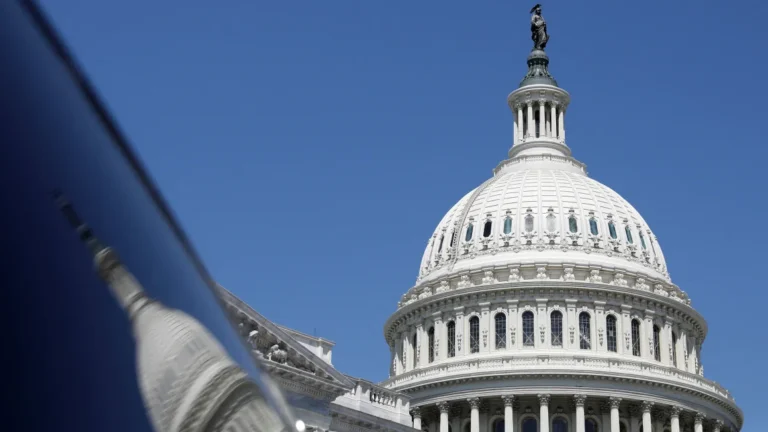 The dome of the US Capitol is reflected in a window on Capitol Hill in Washington, DC, in April. Amanda Andrade-Rhoades/Reuters