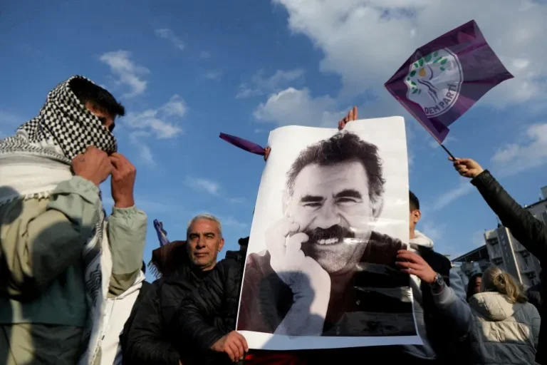 A demonstrator holds a picture of jailed Kurdish leader Abdullah Ocalan during a rally in Diyarbakir, Turkiye, February 27, 2025 [Sertac Kayar/Reuters]