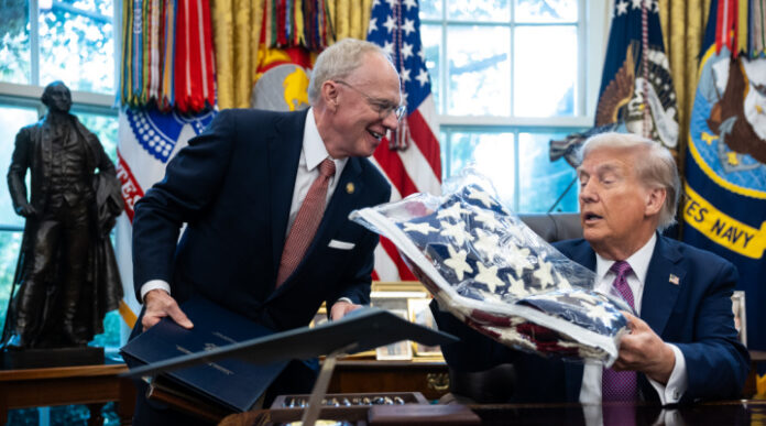 US Rep. John Rose (R-TN) presents a flag to President Donald Trump in the Oval Office at the White House, Sept. 5, 2025. Photo: Francis Chung/Pool/Sipa USA via Reuters Connect