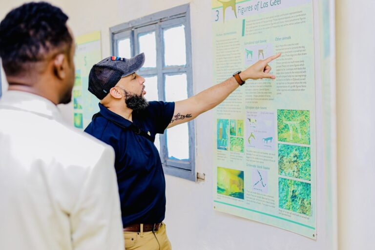 U.S. Chargé d'Affaires Justin Davis examines exhibits explaining the prehistoric Laas Geel cave paintings during a visit to the archaeological site near Hargeisa, Somaliland, June 2026. The site is home to ancient rock art dating back thousands of years. Photo: U.S. Embassy Mogadishu