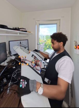 A young engineer conducts field testing of a fixed-wing unmanned aerial vehicle (UAV) prototype, showcasing the development, assembly and flight preparation of an indigenous drone system designed for autonomous operations. The project highlights growing innovation in aerospace engineering, unmanned aviation and next-generation technology.