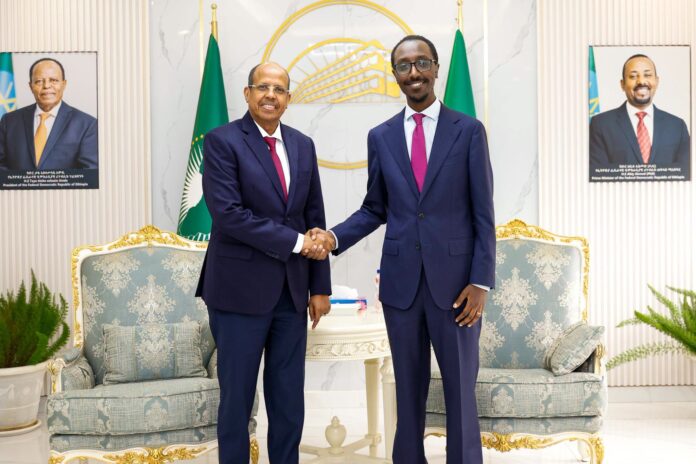 Ethiopia's Minister of Foreign Affairs, Gedion Timothewos (R), shakes hands with African Union Commission Chairperson Mahmoud Ali Youssouf during a meeting at the Ministry of Foreign Affairs in Addis Ababa, Ethiopia, Aug. 5, 2026. The talks focused on regional peace and security in the Horn of Africa and preparations for the 2027 U.N. Climate Change Conference (COP32).