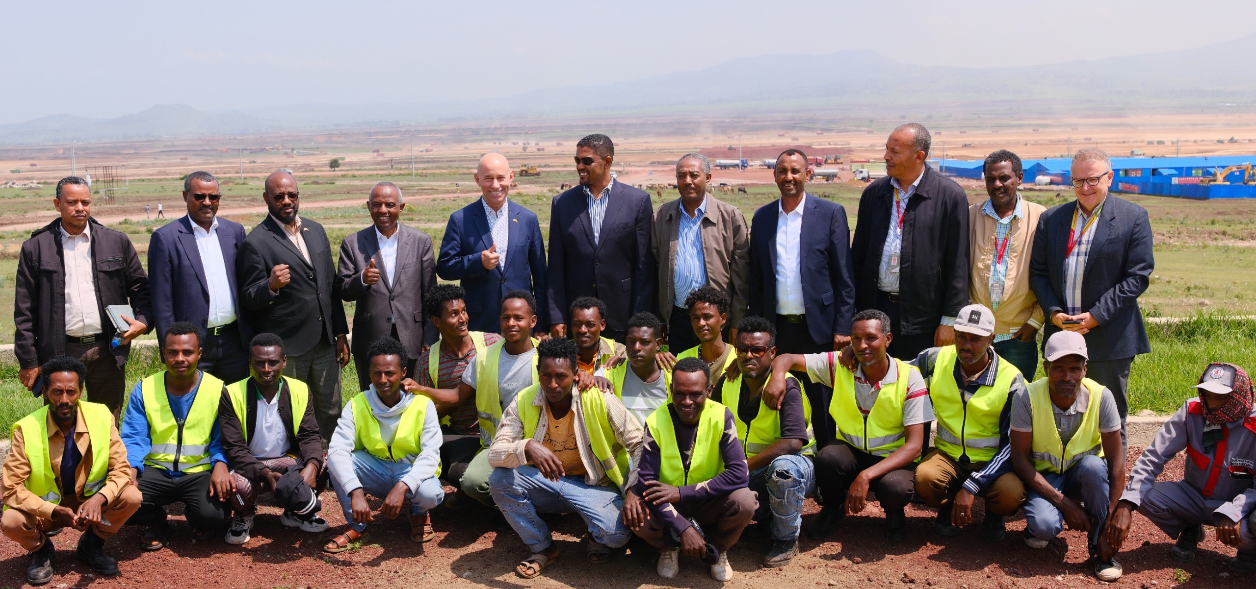 U.S. Assistant Secretary of State for African Affairs Frank Garcia and Ethiopian Airlines CEO Mesfin Tasew pose with officials and construction workers at the Bishoftu International Airport project site in Ethiopia.